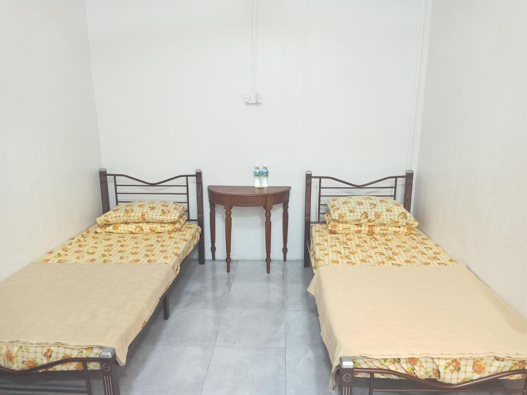 Postel nebo postele na pokoji v ubytování Homestay Roomstay Muar Srizahrani
