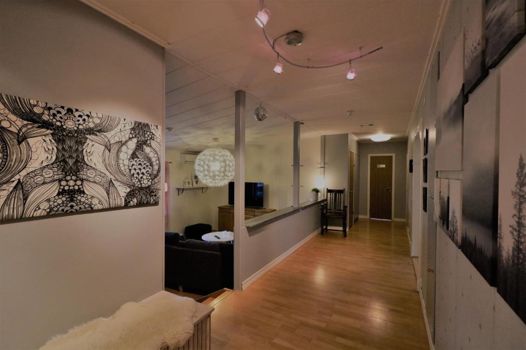 a hallway leading to a living room with a couch at RIBO Apartment Aurora in Kiruna