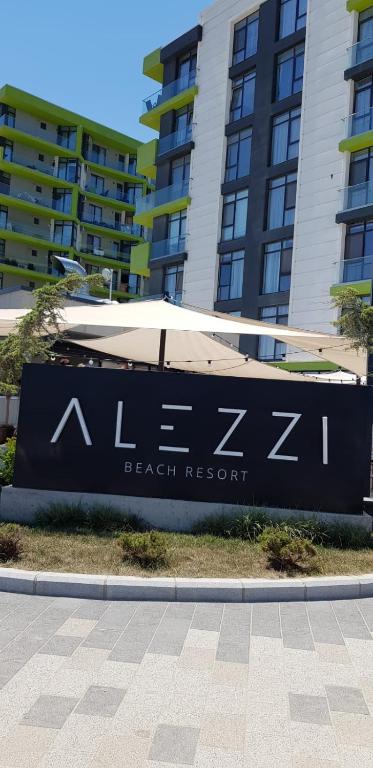a sign for a beach resort in front of a building at RELAX ALEZZI BEACH RESORT in Mamaia Sat/Năvodari