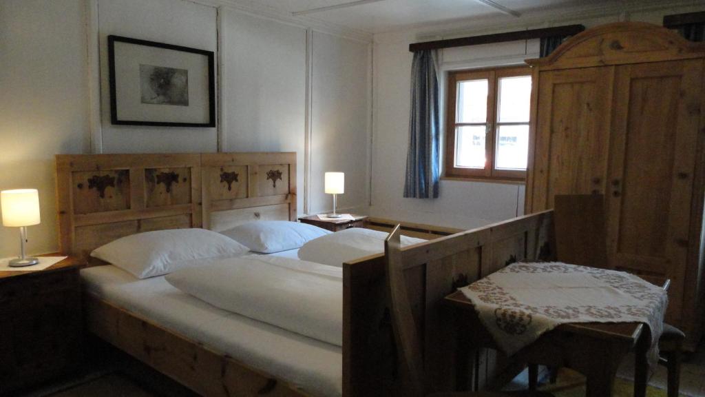 a bedroom with a large bed and a window at Landhaus Schösser-Brandler in Mayrhofen