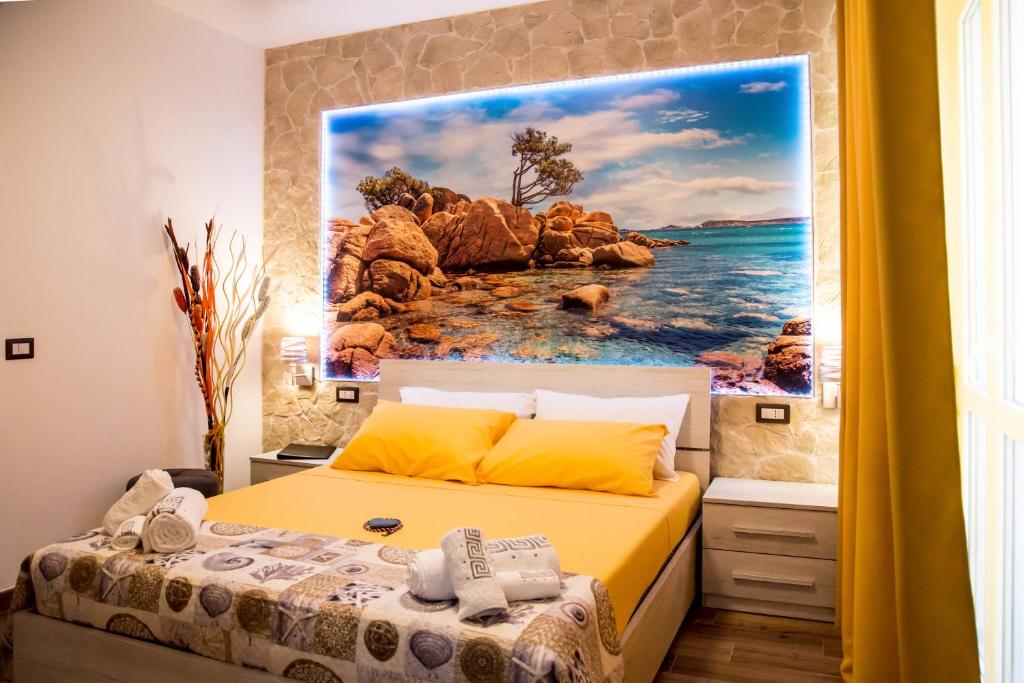 a bedroom with a large painting on the wall at Da Mariolina in Alghero
