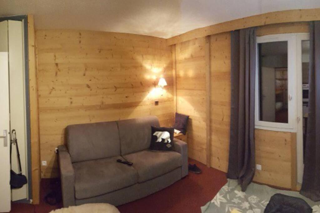 a living room with a couch and a window at La Rosière Montvalezan,pieds des pistes,résidence le Vanoise in La Rosière