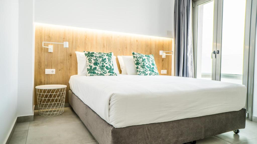 Postel nebo postele na pokoji v ubytování Anfi Suites