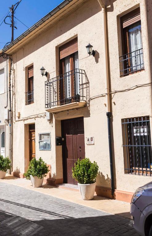 a building with two balconies on a street at EL TEULAR DE CARMEN in Banyeres de Mariola