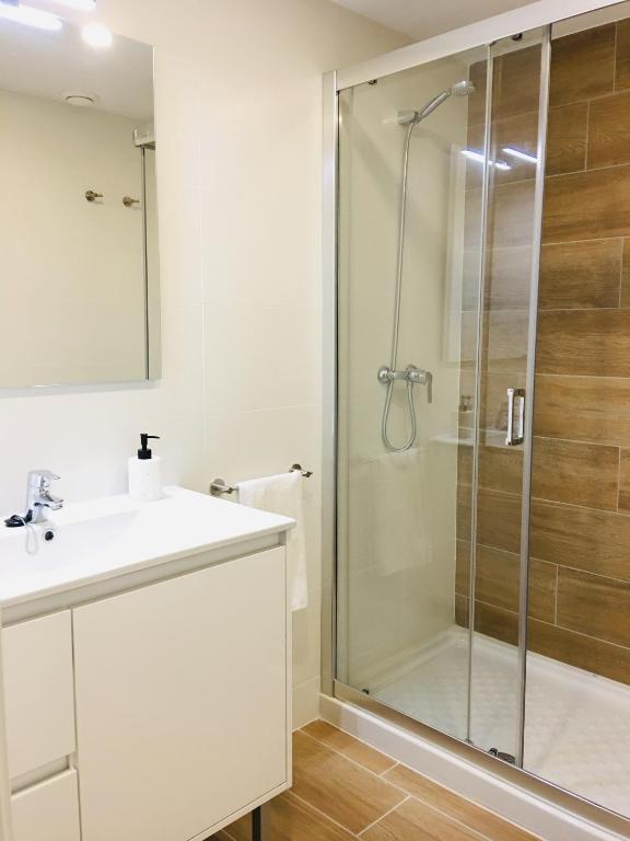 a bathroom with a sink and a shower at Aiguaneu El Celler in Blanes