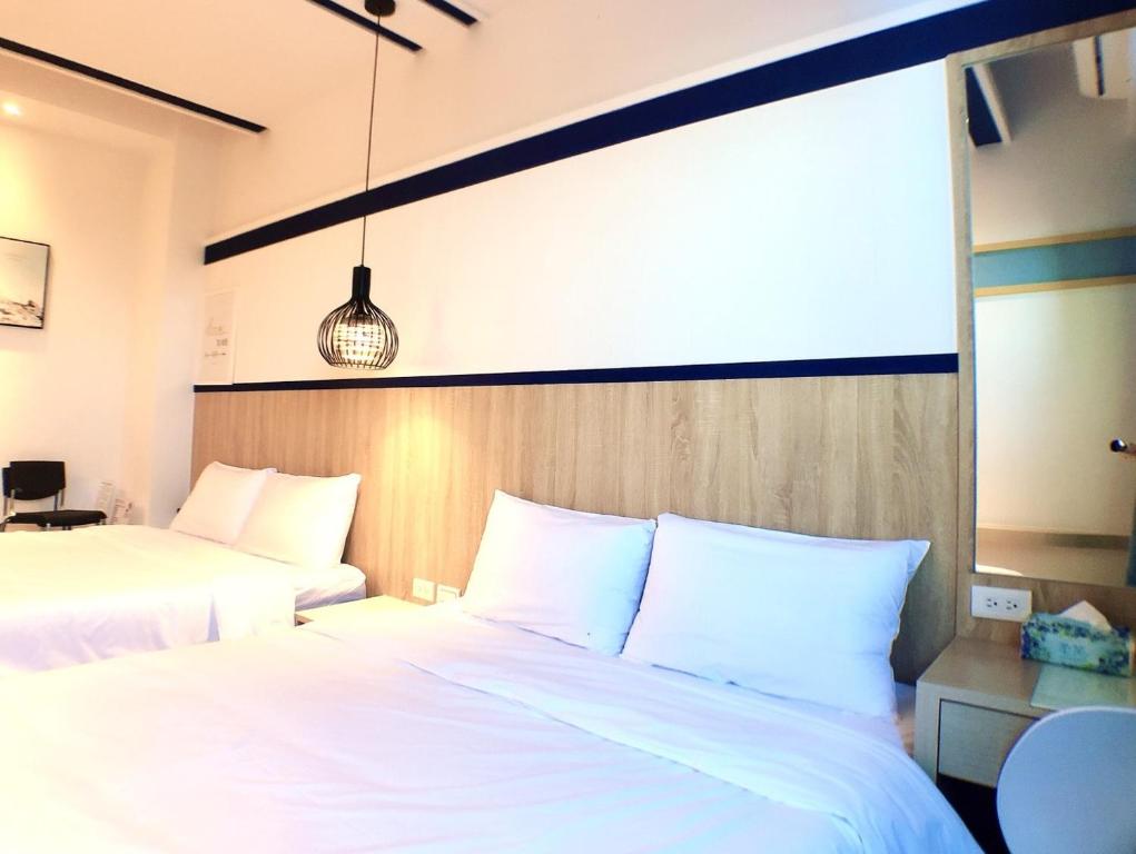 Postel nebo postele na pokoji v ubytování 陽光空氣水海景電梯民宿 Sunshine Air Water Sea View Homestay