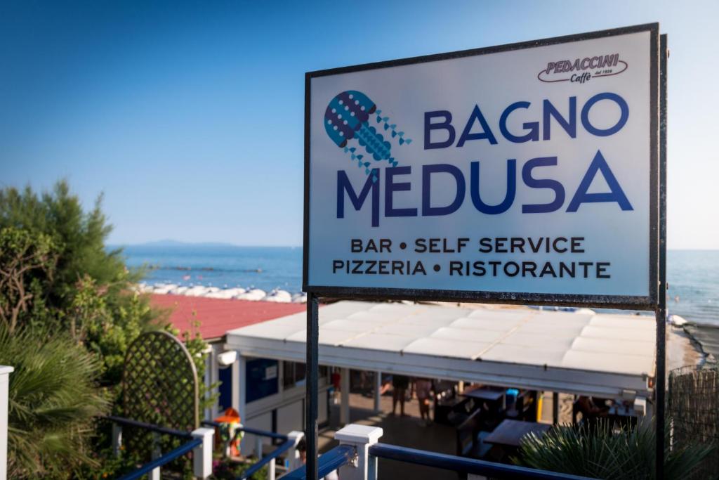 a sign for a barrio mexican restaurant on the beach at Hotel Perla in Castiglione della Pescaia