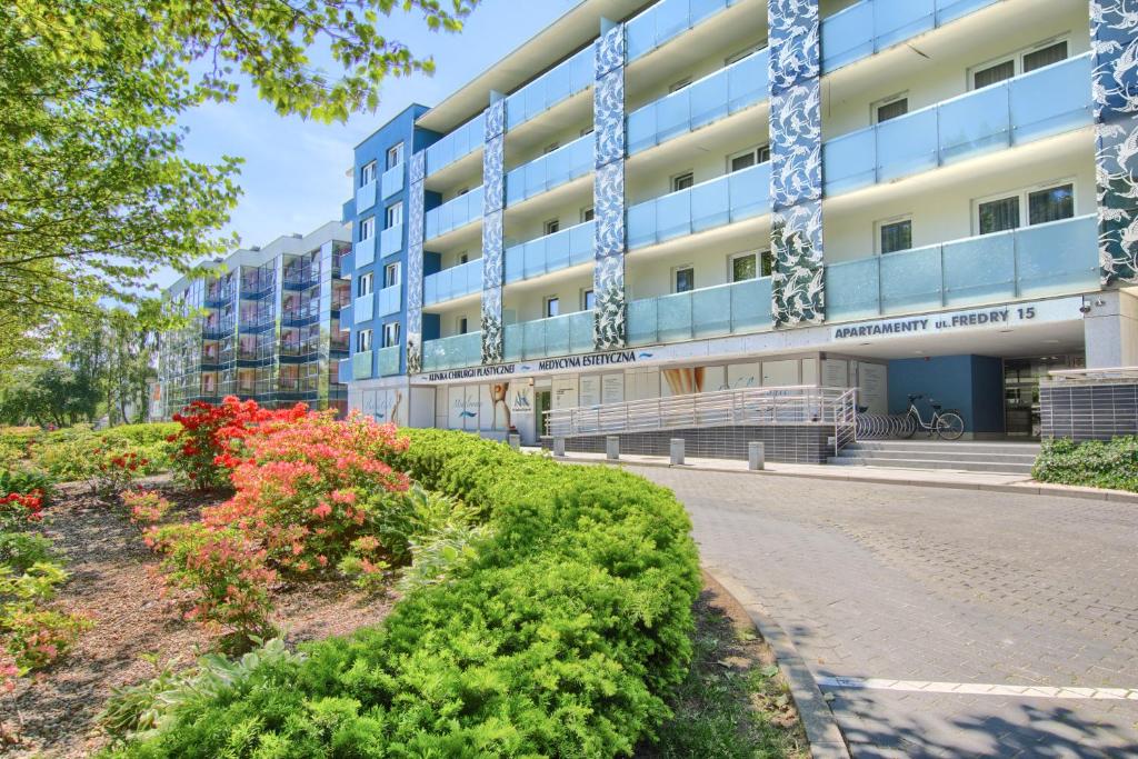 an apartment building with flowers in front of it at Apartamenty PROMENADA - Aquarius in Kołobrzeg