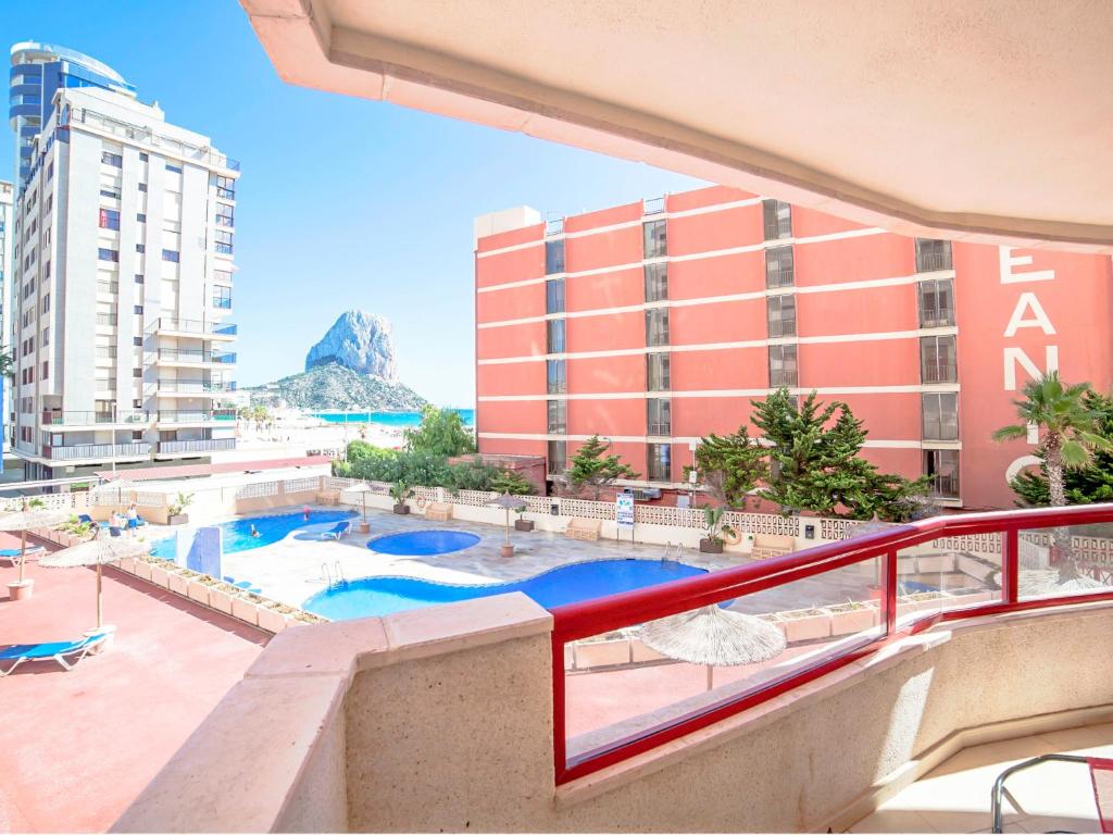 a balcony with a view of a pool and buildings at Apartment Amatista-7 by Interhome in Calpe