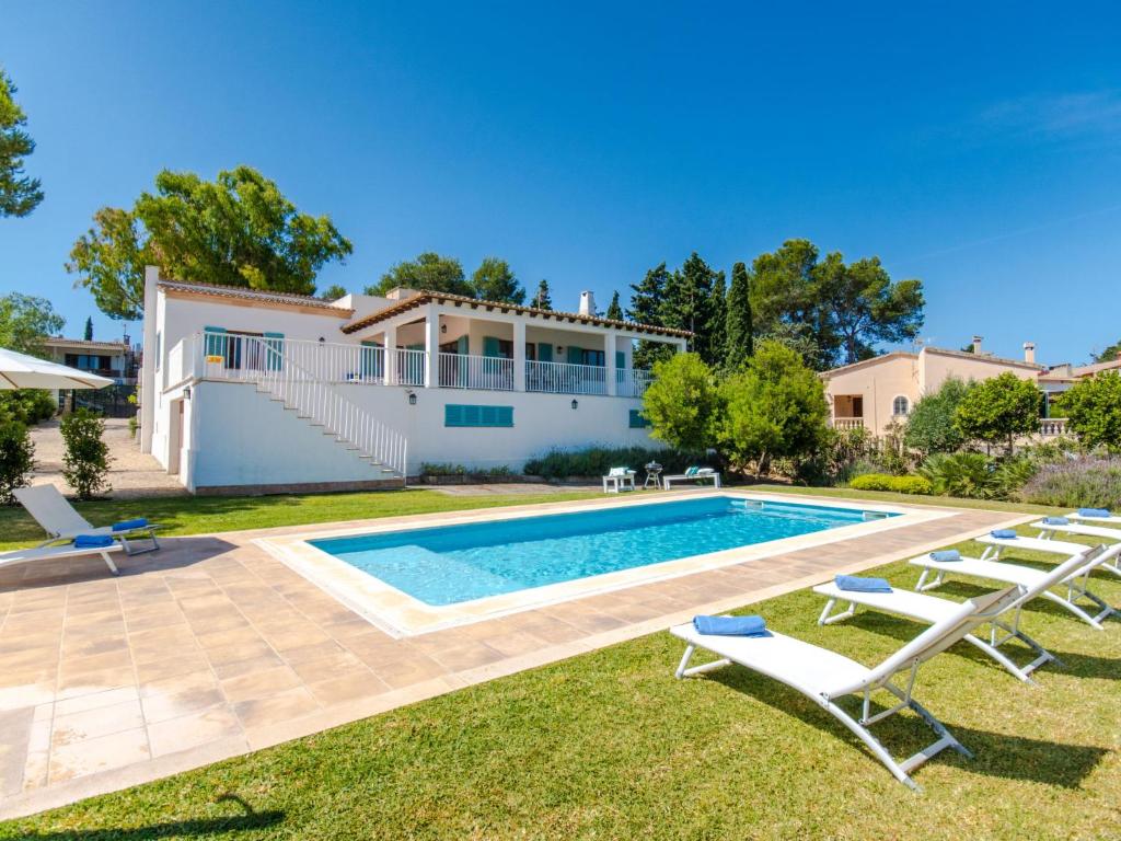 a villa with a swimming pool and lounge chairs at Villa Son Granada by Interhome in Cala Blava