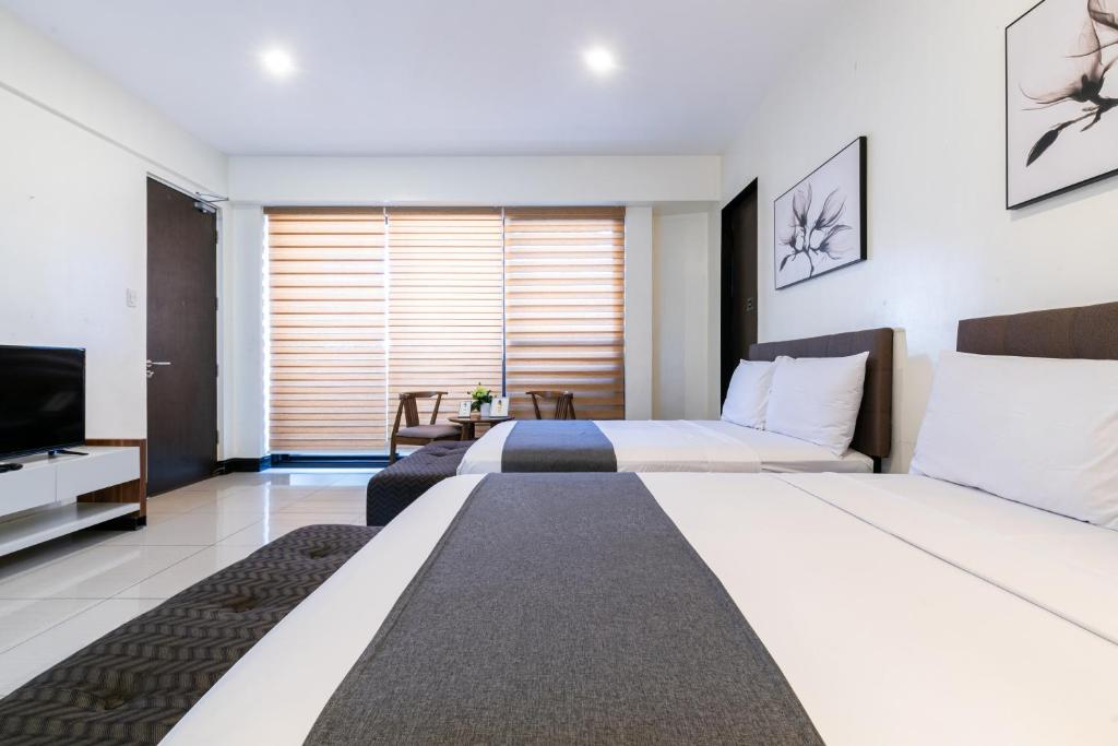 Postel nebo postele na pokoji v ubytování Artemis Place Makati Hotel