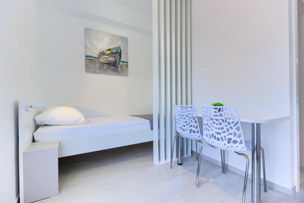 Postel nebo postele na pokoji v ubytování Stipe Residence