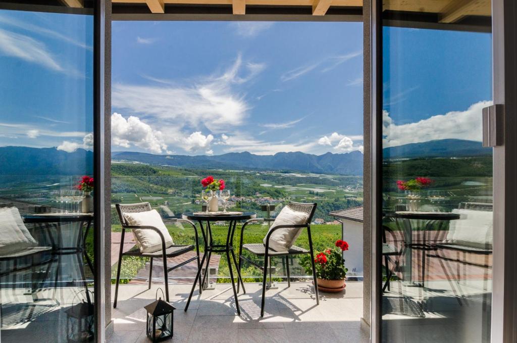 a view from the balcony of a house with a table and chairs at Orizzonti d'Anaunia in Tassullo