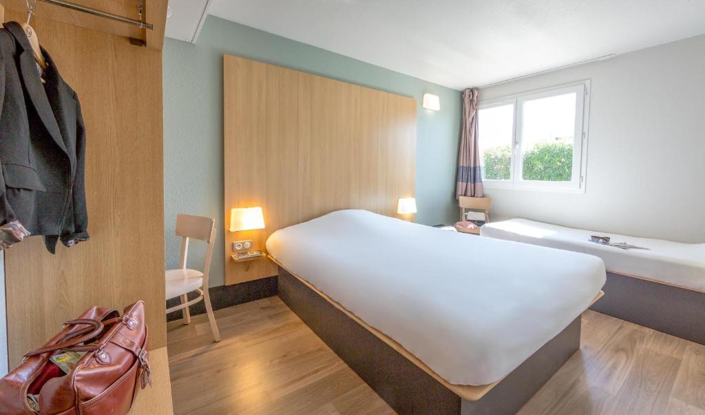 Postel nebo postele na pokoji v ubytování B&B HOTEL PERPIGNAN Nord Aéroport
