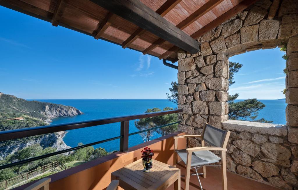 a house with a view of the ocean at Boutique Hotel Torre Di Cala Piccola in Porto Santo Stefano