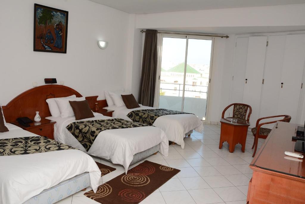 Postel nebo postele na pokoji v ubytování Hotel Bouregreg