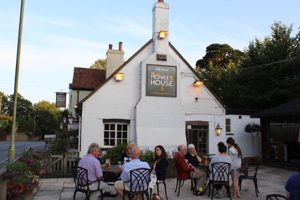 a group of people sitting at a table outside of a house at Monkey Brewhouse in Lymington