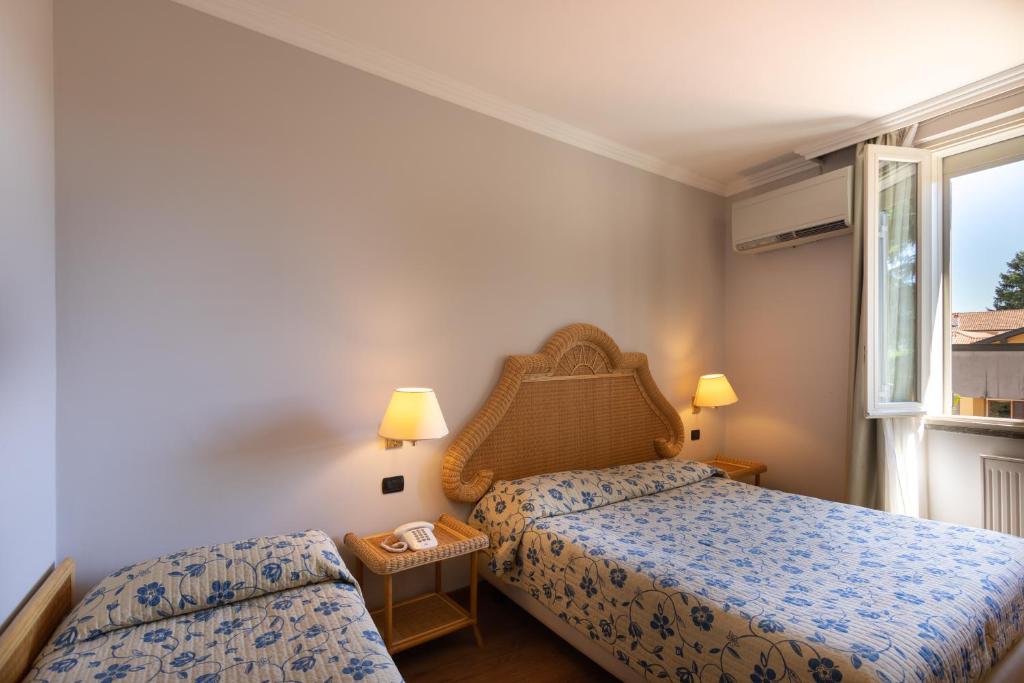 Postel nebo postele na pokoji v ubytování Hotel Dei Tigli
