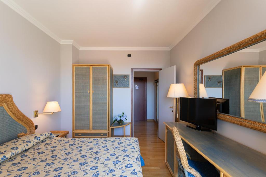 Postel nebo postele na pokoji v ubytování Hotel Dei Tigli