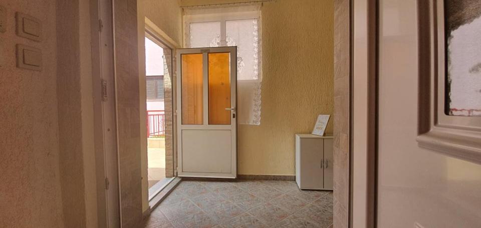 a hallway with an open door and a refrigerator at Apartments New Charming in Senj