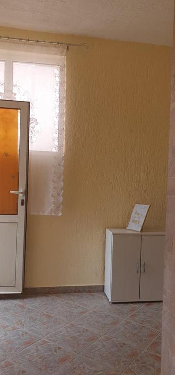 an empty room with a window and a refrigerator at Apartments New Charming in Senj