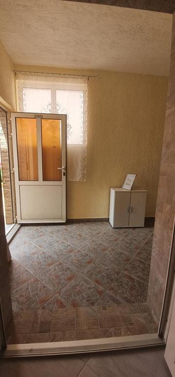 an empty room with a door and a box at Apartments New Charming in Senj