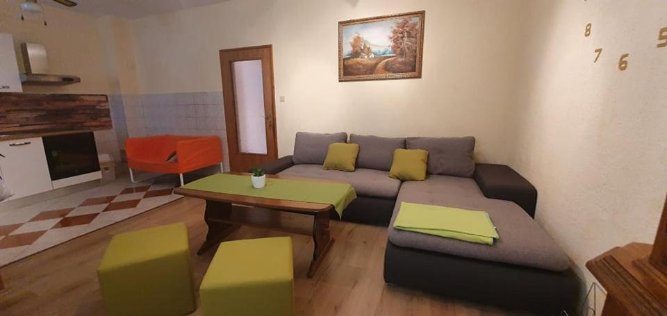 a living room with a couch and a table at Apartments New Charming in Senj