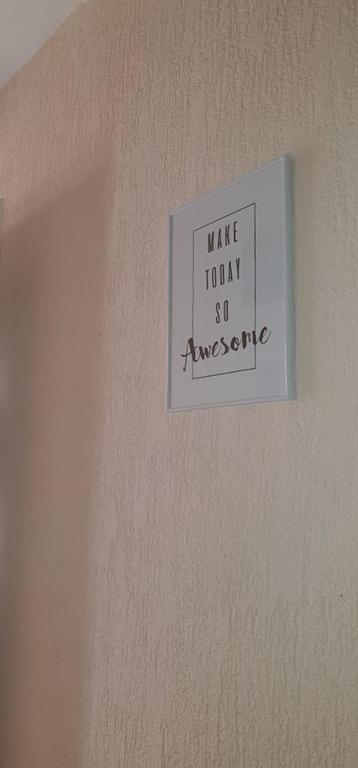 a sign on a wall that reads make today so awesome at Apartments New Charming in Senj