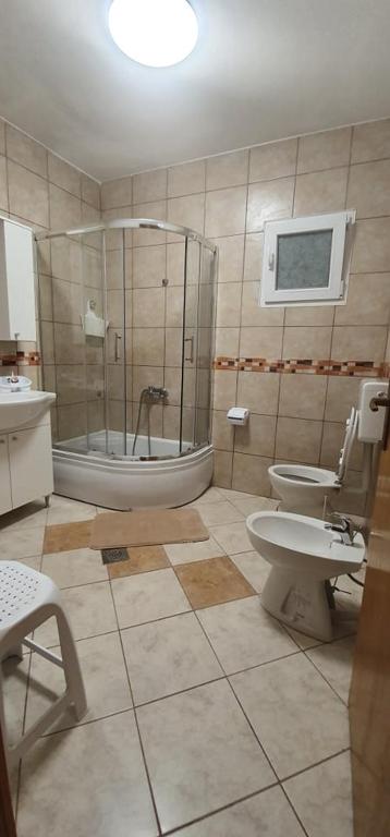 a bathroom with a shower and two toilets in it at Apartments New Charming in Senj