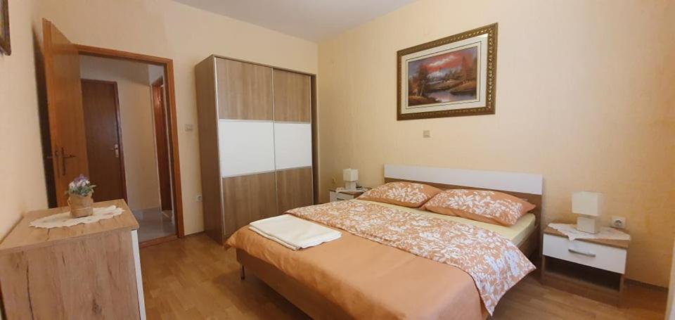 a bedroom with a large bed in a room at Apartments New Charming in Senj