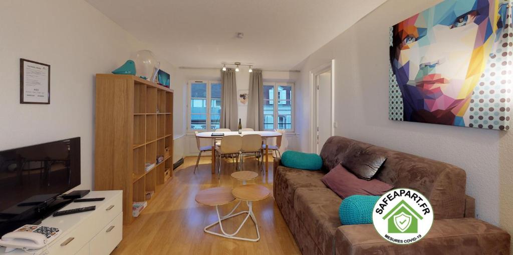 a living room with a couch and a table at 70 m² Strasbourg Appart city center in Strasbourg
