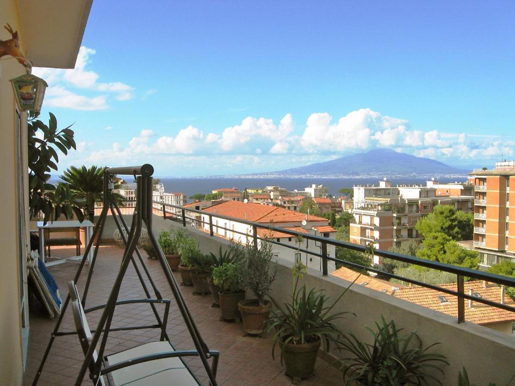 a ladder on a balcony with a view of a city at Apartment Top Floor by Interhome in Sorrento