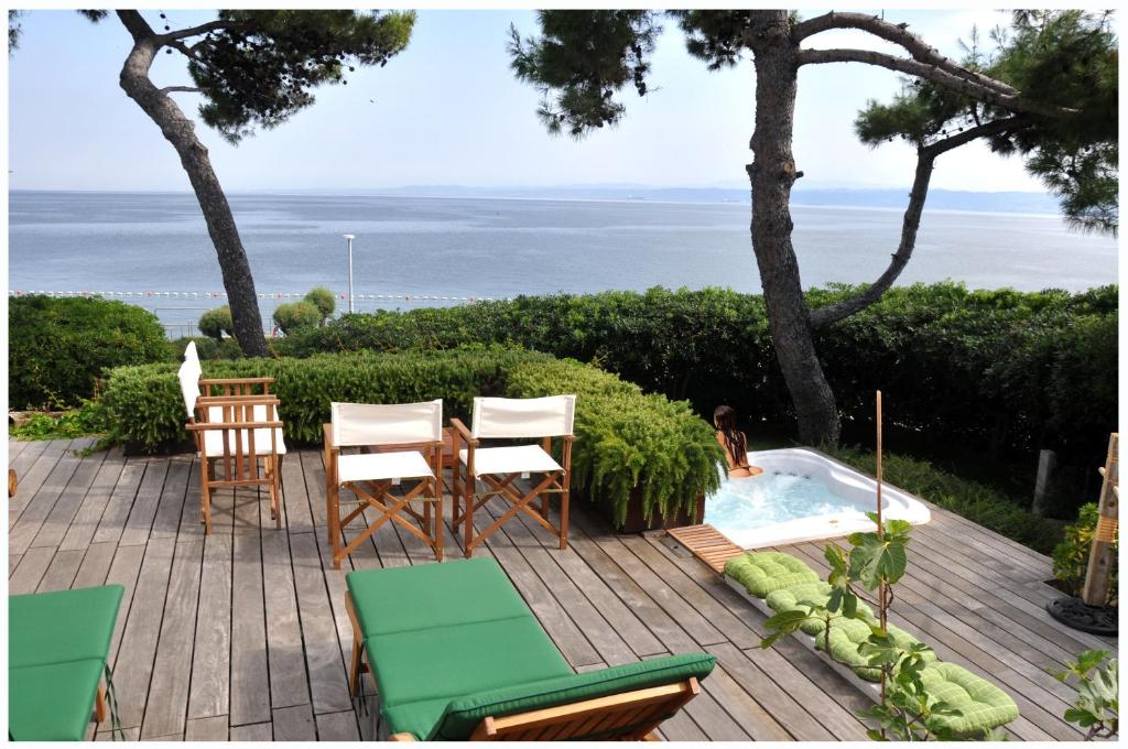 um pátio com cadeiras, uma mesa e uma piscina em Premium apartment Natura em Izola
