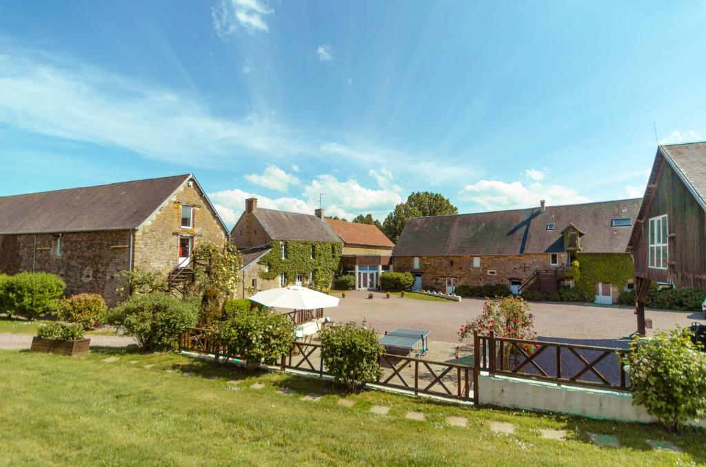 a group of buildings with a park in the middle at la ferme des epis in Ouffières