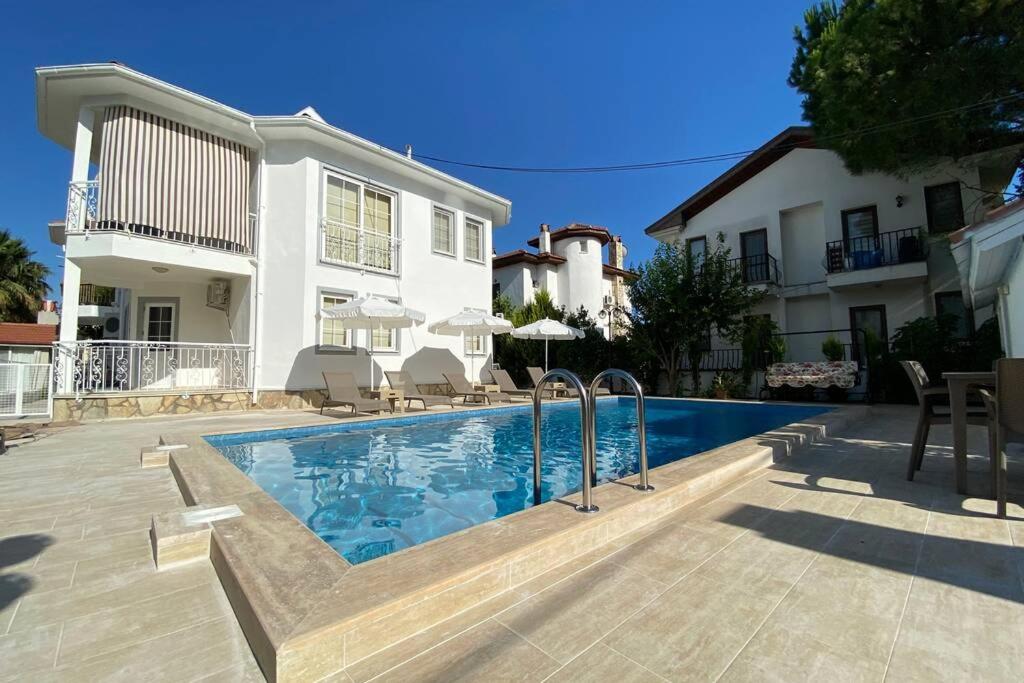 a swimming pool in front of a house at Villa Acar - 4 Bedroom Villa in Dalyan Center, Private Pool&Garden in Mugla