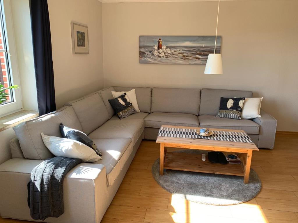 a living room with a couch and a coffee table at Buxbuddies Admirals Inn in Fehmarn