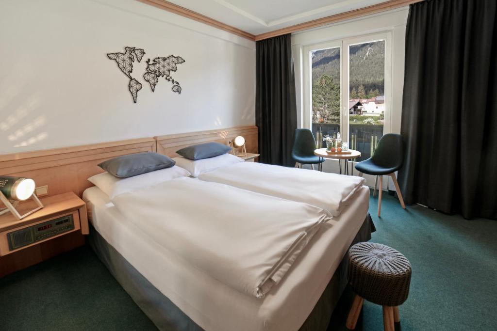 Postel nebo postele na pokoji v ubytování Boutique Hotel Olympia