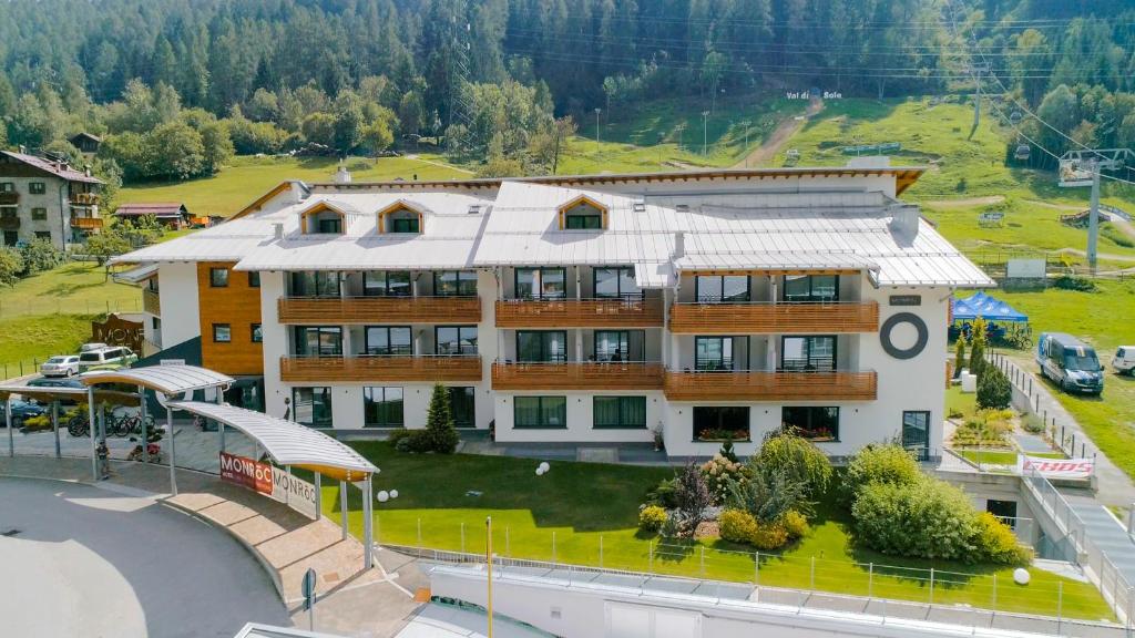 an aerial view of a large building in the mountains at Monroc Hotel in Commezzadura