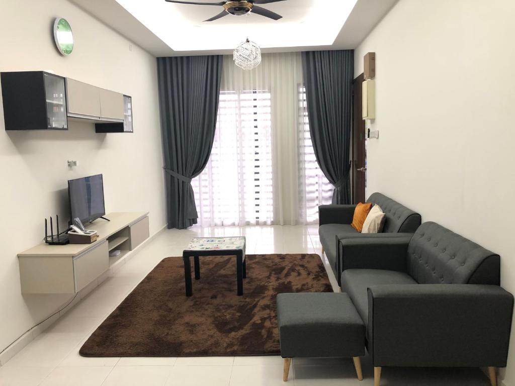 a living room with a couch and a tv at Evergreen 1 Homestay Kuantan in Kuantan