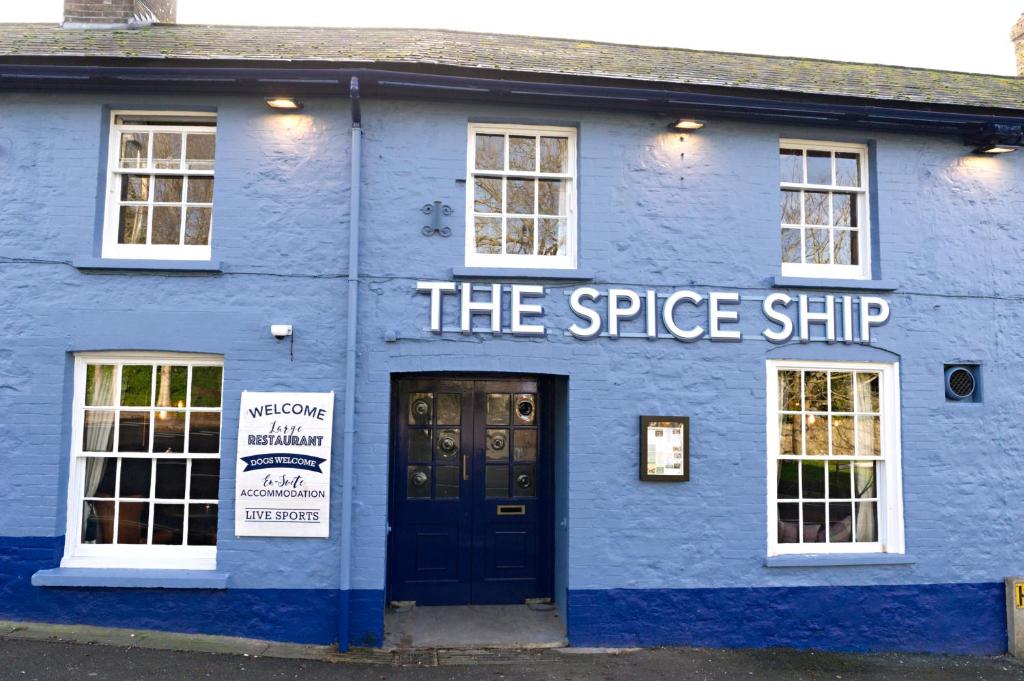 a blue and white building with a sign on it at The Spice Ship in Weymouth