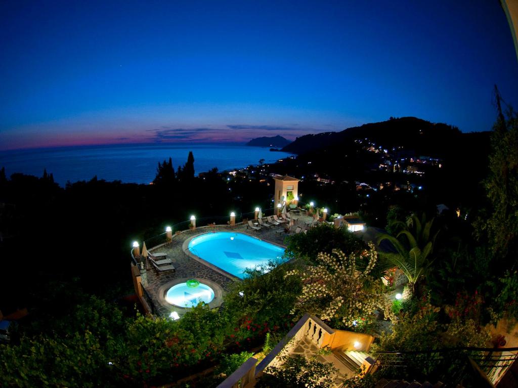 a view of a swimming pool at night at Dina's Paradise in Agios Gordios