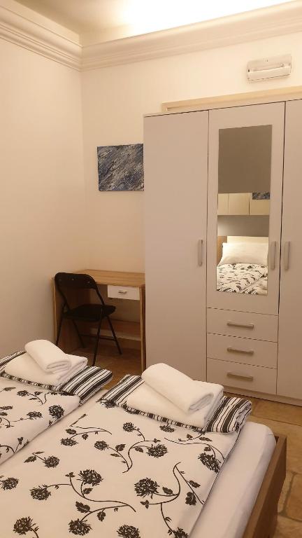 Posteľ alebo postele v izbe v ubytovaní Apartmani N.May's