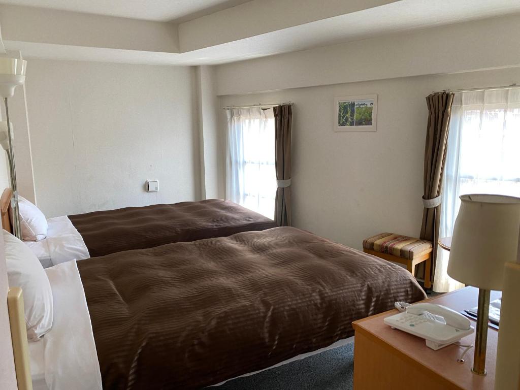 Postel nebo postele na pokoji v ubytování Sakura Hotel Hatagaya