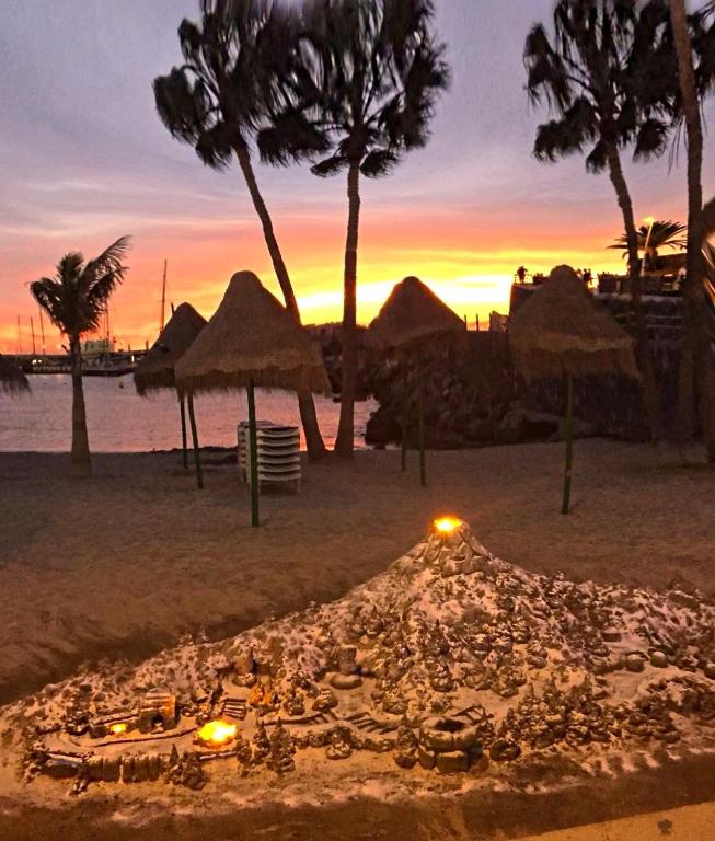 a fire pit on the beach at sunset at Ocean View Apartment in Palm-Mar