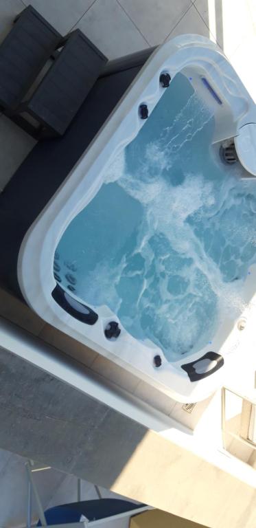 a bath tub with blue water in a boat at Appartamenti porta mare in Otranto