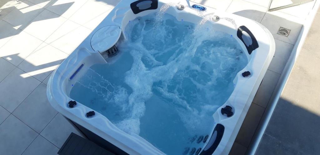 a bath tub filled with blue water on top of a floor at Appartamenti porta mare in Otranto