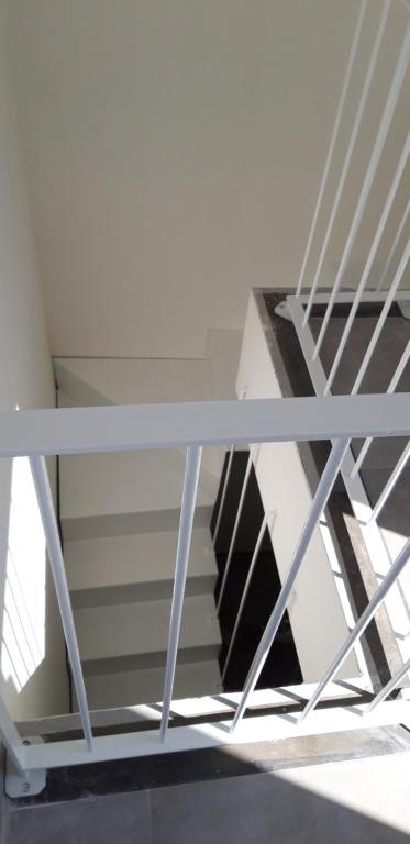 a white table with a staircase in a room at Appartamenti porta mare in Otranto