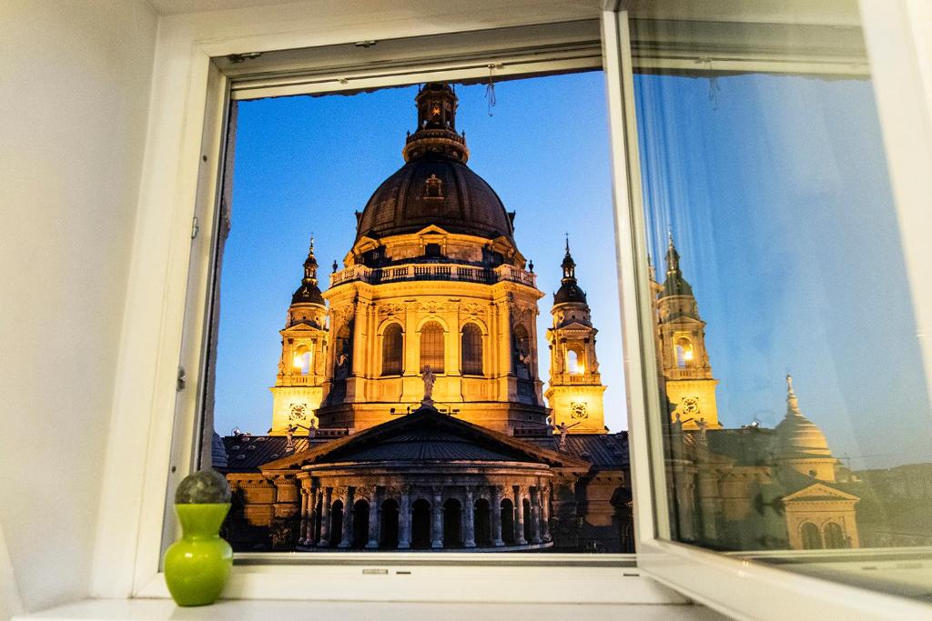 a view of a building through a window at Helena apartment with view on St. Stephan's Basilica in Budapest