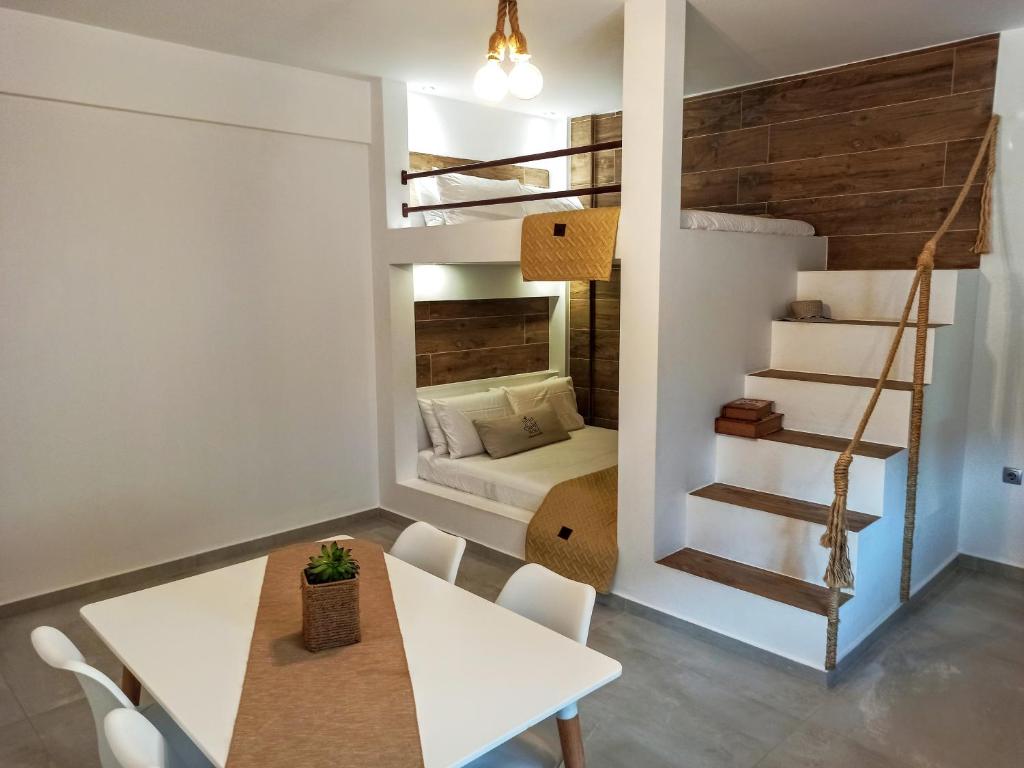 a small apartment with a dining room and a loft bed at Home Sweet Home in Ammoudia