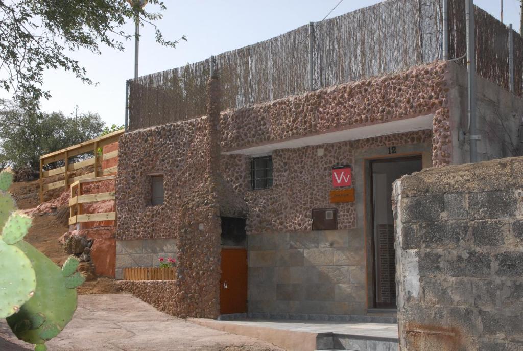 a brick building with a sign on it at Casa Roque in Telde